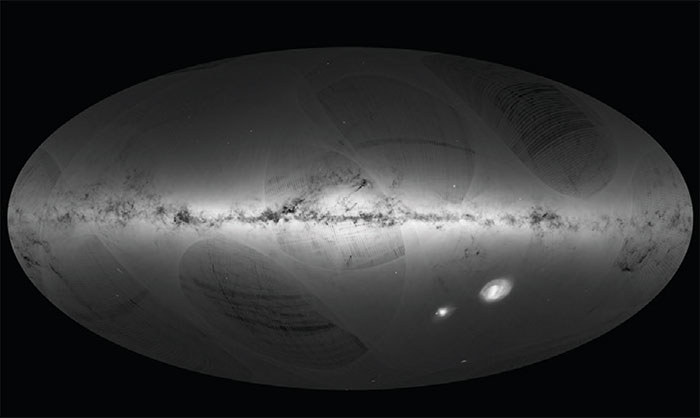 An all-sky view of stars in the first Gaia catalogue. With a dot for each star, the map outlines the Milky Way (horizontally) and the Magellanic Clouds (lower right). The curved features are artifacts due to Gaia’s scanning procedure. Image credit: ESA/Gaia/DPAC.